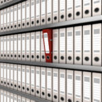 In the Loop: Filer under fire, offset blessing and SEC confusion red ring binder standing out from a row of files