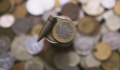 Engagement initiative targets defence-related disclosure transparency Image of a euro coin and a bullet side-by-side.