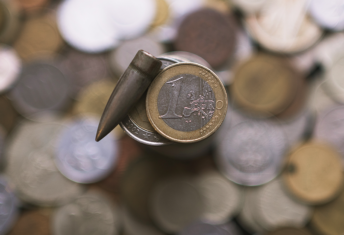 Engagement initiative targets defence-related disclosure transparency Image of a euro coin and a bullet side-by-side.