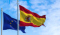 The flags of Spain and the European Union waving in the wind on a sunny day. Democracy and politics. European country.