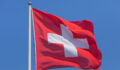 https://www.gettyimages.co.uk/detail/photo/flag-of-switzerland-against-clear-blue-sky-on-a-royalty-free-image/1031668640?phrase=swiss+flag