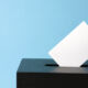 ballot box with voting paper in hole