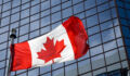 Mixed response to Canadian taxonomy ‘abatement measures’ category Canadian flag in front of modern building.