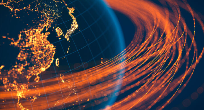Global development capital illustrated by lines of light orbiting the globe
