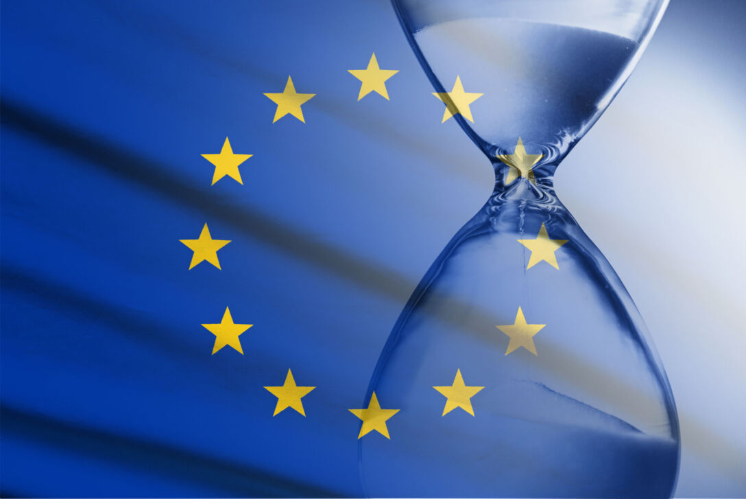 Composite image of the EU flag and hourglass in a concept of passing time and countdown to a deadline
