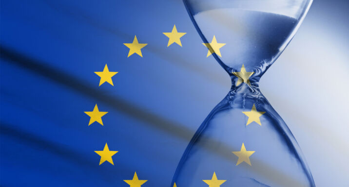 Composite image of the EU flag and hourglass in a concept of passing time and countdown to a deadline