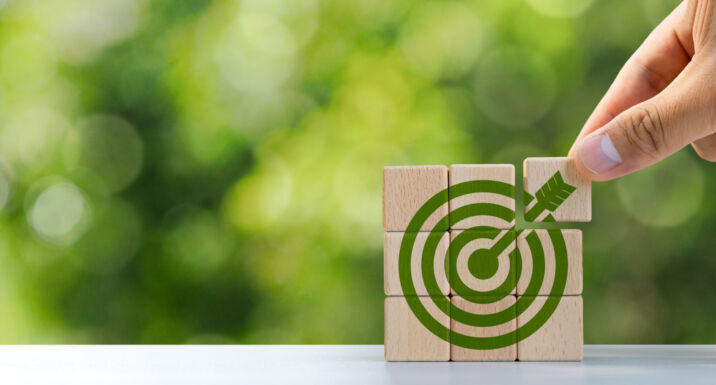 Environmental goals of green business Business development strategy with sustainable environmental conservation wooden block on handle With a green target icon. copy space