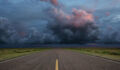Desert road with storm clouds