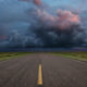 The long road ahead: Engaging with hard-to-abate sectors Desert road with storm clouds