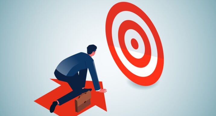 Photo of a person on an arrow that is moving toward a target.
