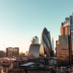 Wide angle of sun setting over London Gherkin.