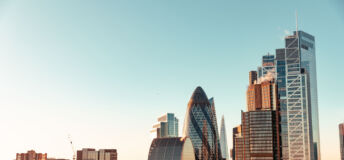 Wide angle of sun setting over London Gherkin.