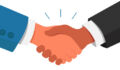 two people shaking hands (just hands are visible)
