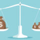 Image of a scale balancing money bags on both sides.