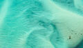 Investors ramp up engagement pressure An aerial photo of sands covered by water