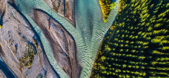 An aerial photo of a forest and rivers running alongside