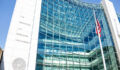 SEC entrance architecture modern building sign, logo, american flag, looking up sky, glass windows reflection
