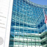 SEC entrance architecture modern building sign, logo, american flag, looking up sky, glass windows reflection