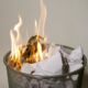 A photo of a waste paper basket that has been set on fire