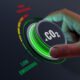 Hand turning dial marked CO2 to "low emissions"