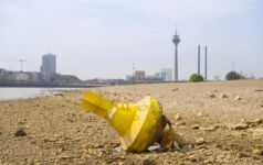 German investors engage firms on Rhine low water levels Low stream gauge of rhine river.Water shortage, drought, climate change,global warming concept, dry river bed with skyline of the town of dรผsseldorf, germany in the background