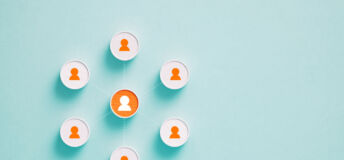 Cylinder objects with human symbols on blue background. One of the objects is orange colored. Horizontal composition with copy space.